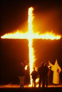 ca. 1987, Near Twin Falls, Idaho, USA --- Members of the Ku Klux Klan and the Aryan Nations gather outside Twin Falls, Idaho for a cross burning. --- Image by © Matthew Mcvay/CORBIS