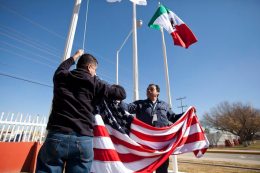 In this Friday, Dec. 27, 2013 photo, workers at one of maquiladoras of the TECMA group prepare to raise the U.S. flag along with the Mexican and TECMA flags in Ciudad Juarez, Mexico. TECMA currently has 14 maquiladora plants in Ciudad Juarez. With the implementation of the North American Free Trade Agreement twenty years ago, many North American and international companies have moved their manufacturing to Mexico at a lower cost and while a majority of Mexicans have seen little benefit in income. While there is undoubtedly a larger middle class today, Mexico is the only major Latin American country where poverty also has grown in recent years. (AP Photo/Ivan Pierre Aguirre)