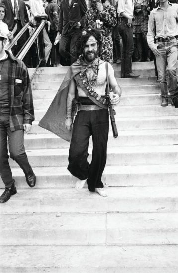 American activist Jerry Rubin (1938 - 1994) smiles as he walks down the steps barefoot outside the 1968 Democratic National Convention, Chicago, Illinois, August 1968. Rubin, who founded the Yippees political party, and six others, called the Chicago Seven, were indicted for conspiracy and inciting a riot during the convention. (Photo by Hulton Archive/Getty Images)