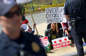 Actress Rosario Dawson, center, takes part in a demonstration on Capitol Hill in Washington, Friday, April 15, 2016. The demonstration, called Democracy Spring, is advocating a set of reforms the organizers have dubbed the 'democracy movement' demanding Congress amend campaign finance laws and restore the Voting Rights Act, among other actions. (AP Photo/Pablo Martinez Monsivais)