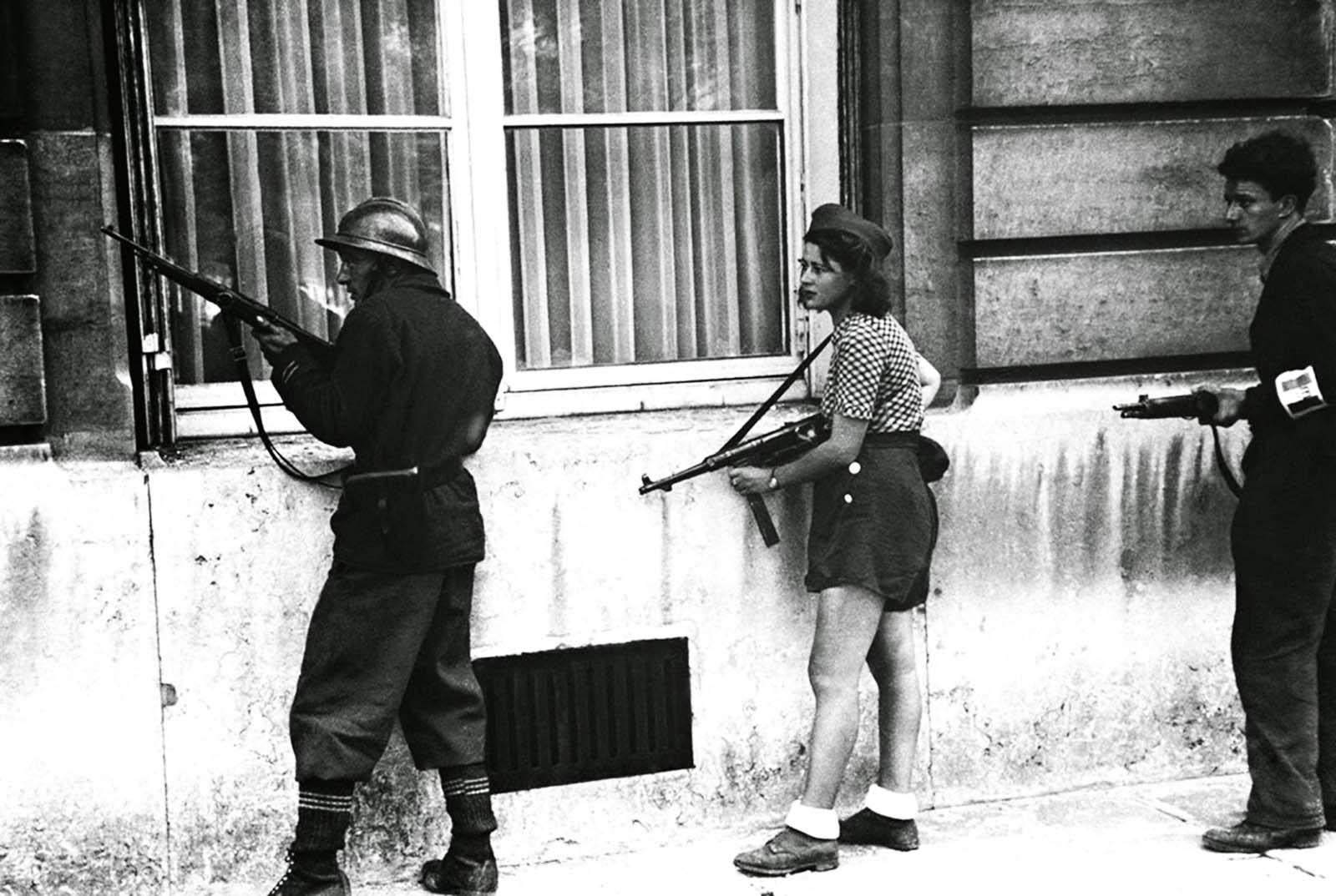 Simone is pictured taking cover during the liberation of Paris in August 1944.